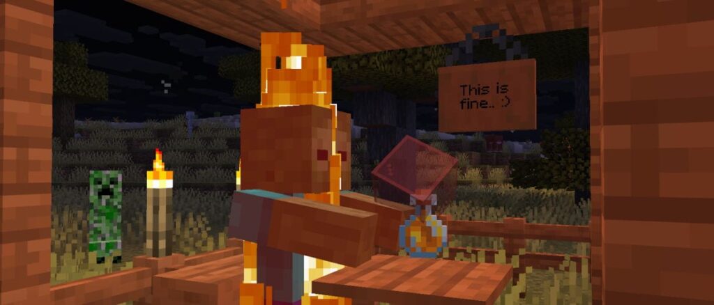 Minecraft 1.21.11 Release Candidate 3 A Zombie in a Savanna Village, burning during the night. A sign reading "This is fine" is placed in the background. The Zombie is also holding a Red Stained Glass block, and a Honey Bottle is dropped in front of the Zombie.