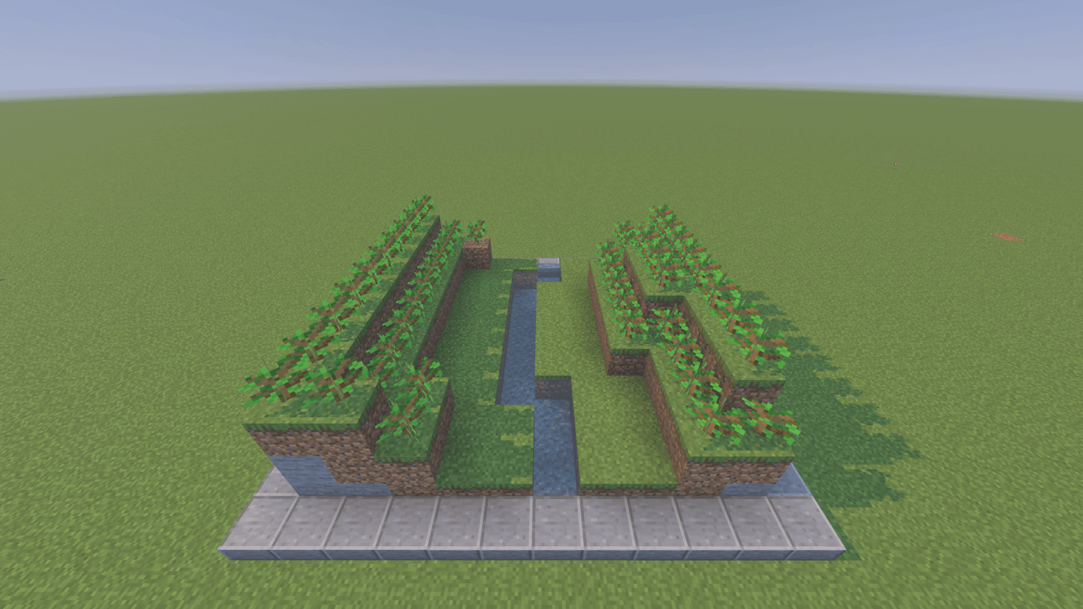 両側に森があり、川が流れている浅い谷