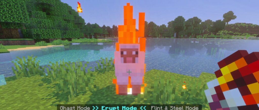 A sheep is set ablaze by a player using 'erupt mode' near a lake in a grassy biome